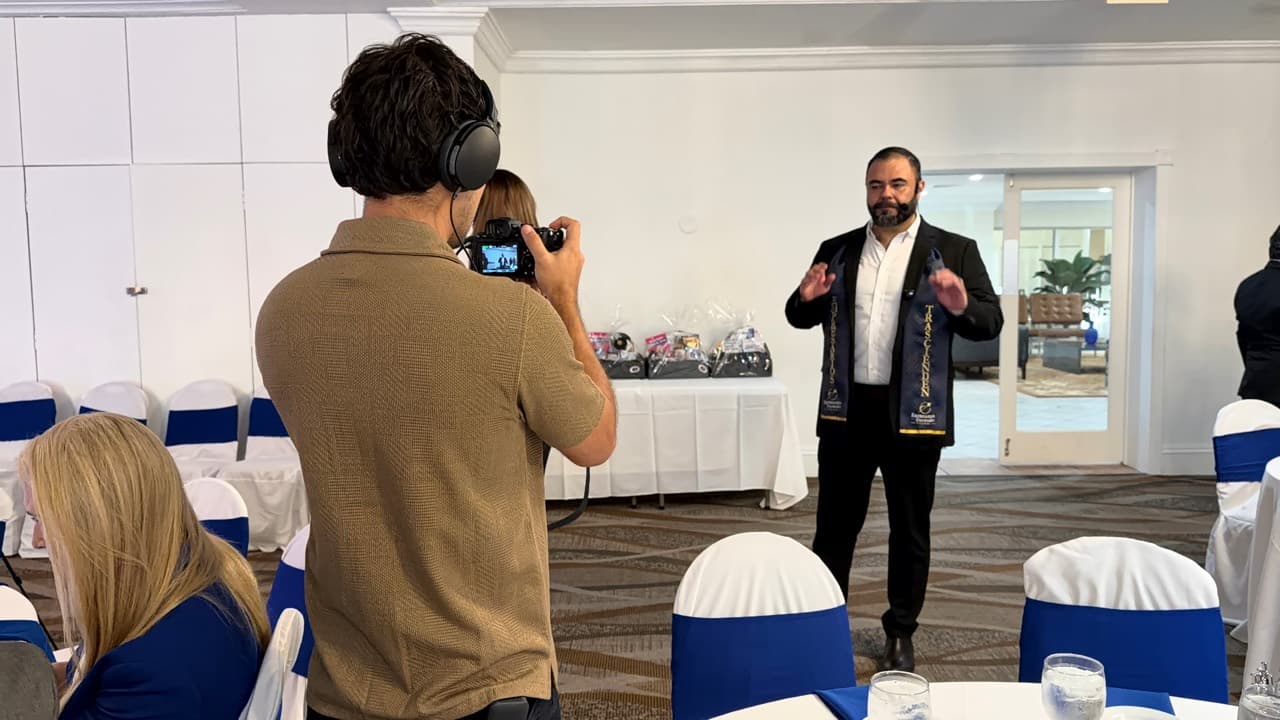 Esteban filming a live conference speaker